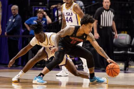 Dec 17, 2022; Baton Rouge, Louisiana, USA;  Winthrop Eagles guard Kasen Harrison (11) dribbles against LSU Tigers guard Cam Hayes (1) during the first half at Pete Maravich Assembly Center. Mandatory Credit: Stephen Lew-USA TODAY Sports