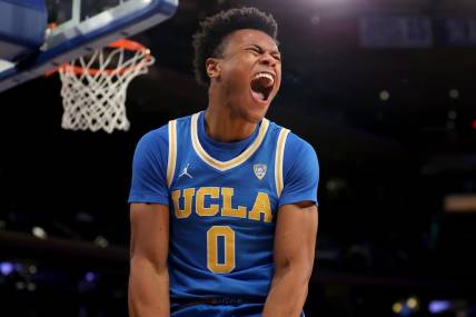 Dec 17, 2022; New York, New York, USA; UCLA Bruins guard Jaylen Clark (0) reacts after dunking against the Kentucky Wildcats during the final seconds of the second half at Madison Square Garden. Mandatory Credit: Brad Penner-USA TODAY Sports