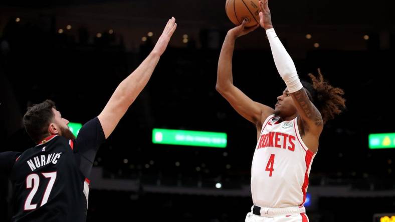 Dec 17, 2022; Houston, Texas, USA; Houston Rockets guard Jalen Green (4) takes a jumps shot while Portland Trail Blazers center Jusuf Nurkic (27) defends during the first quarter at Toyota Center. Mandatory Credit: Erik Williams-USA TODAY Sports