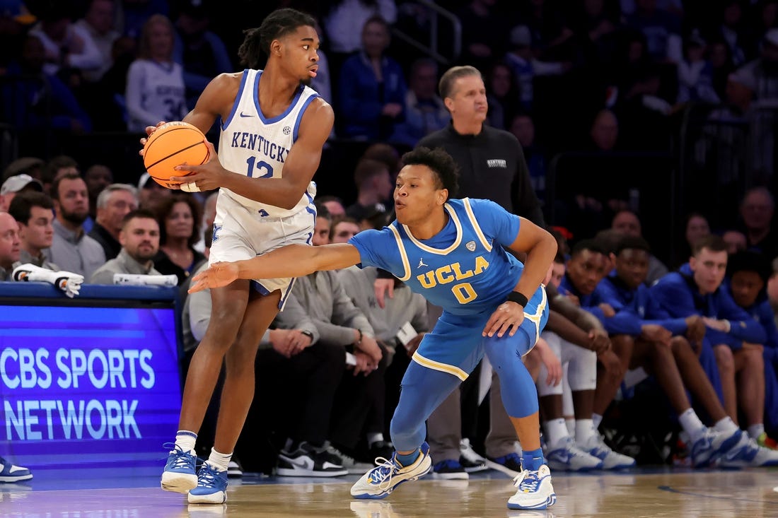 Dec 17, 2022; New York, New York, USA; Kentucky Wildcats guard Antonio Reeves (12) controls the ball against UCLA Bruins guard Jaylen Clark (0) during the second half at Madison Square Garden. Mandatory Credit: Brad Penner-USA TODAY Sports