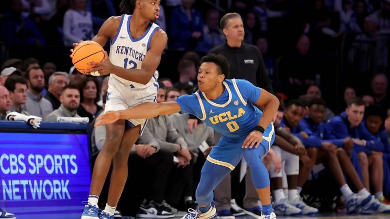 Dec 17, 2022; New York, New York, USA; Kentucky Wildcats guard Antonio Reeves (12) controls the ball against UCLA Bruins guard Jaylen Clark (0) during the second half at Madison Square Garden. Mandatory Credit: Brad Penner-USA TODAY Sports