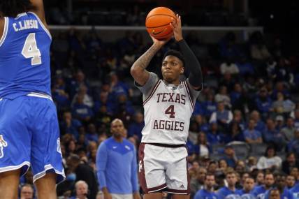 Dec 17, 2022; Memphis, Tennessee, USA; Texas A&M Aggies guard Wade Taylor IV (4) shoots for three during the second half against the Memphis Tigers at FedExForum. Mandatory Credit: Petre Thomas-USA TODAY Sports