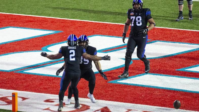 Dec 17, 2022; Albuquerque, New Mexico, USA; Brigham Young Cougars running back Christopher Books (2) celebrates after scoring a touchdown against the Southern Methodist Mustangs at University Stadium (Albuquerque). Mandatory Credit: Ivan Pierre Aguirre-USA TODAY Sports