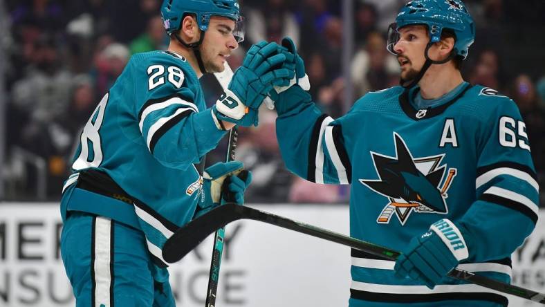 Dec 17, 2022; Los Angeles, California, USA; San Jose Sharks right wing Timo Meier (28) celebrates his power play goal scored against the Los Angeles Kings with defenseman Erik Karlsson (65) during the first period at Crypto.com Arena. Karlsson provided an assist on the goal. Mandatory Credit: Gary A. Vasquez-USA TODAY Sports