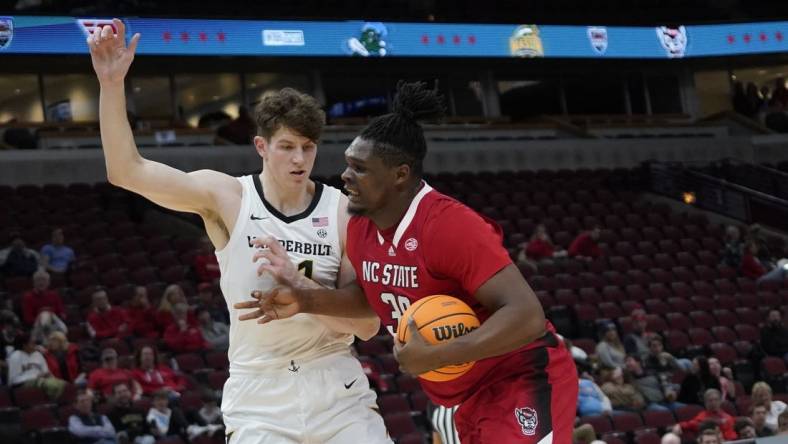 Dec 17, 2022; Chicago, Illinois, USA; Vanderbilt Commodores forward Liam Robbins (21) defends North Carolina State Wolfpack forward D.J. Burns Jr. (30) during the first half  at United Center. Mandatory Credit: David Banks-USA TODAY Sports