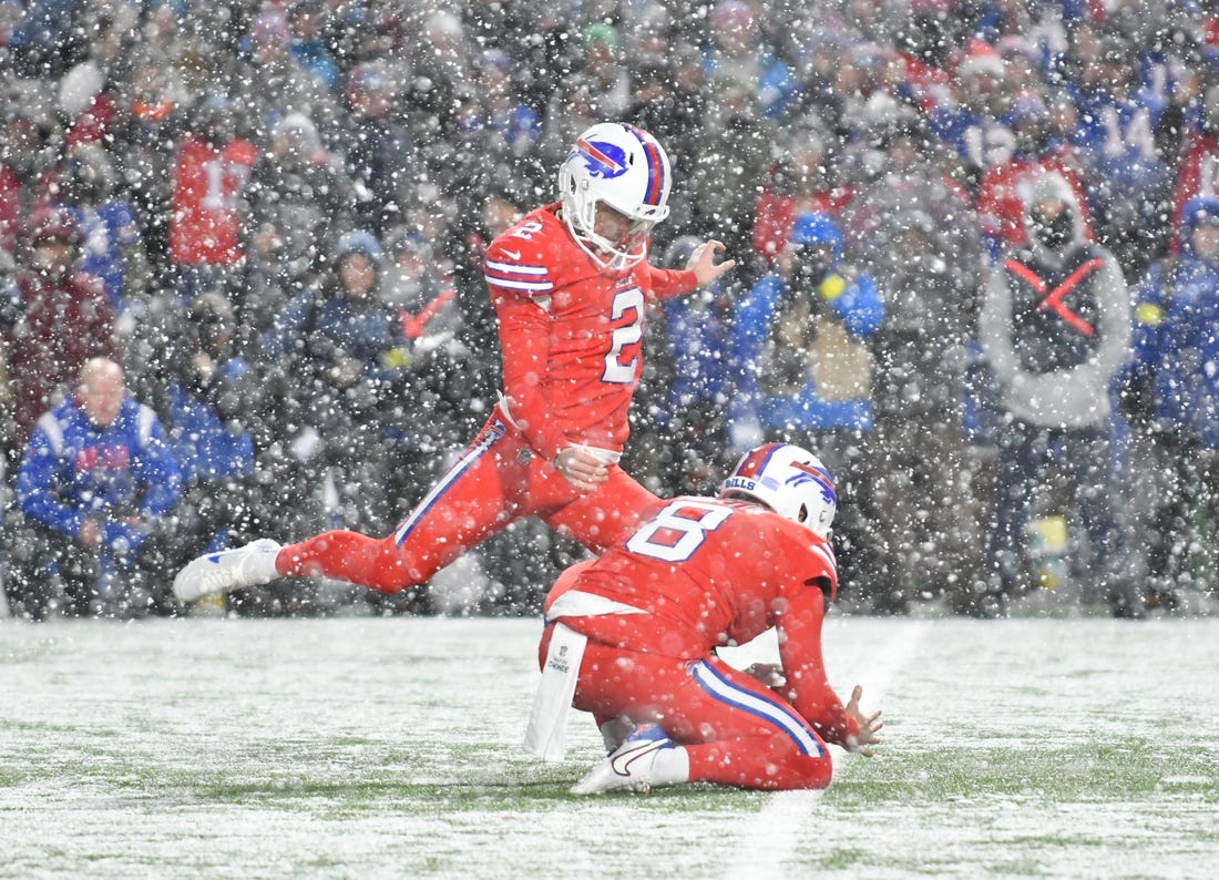 Dec 17, 2022; Orchard Park, New York, USA; Buffalo Bills place kicker Tyler Bass (2) kicks the winning field goal against the Miami Dolphins as punter Sam Martin (8) places the ball as time expires at Highmark Stadium. Mandatory Credit: Mark Konezny-USA TODAY Sports