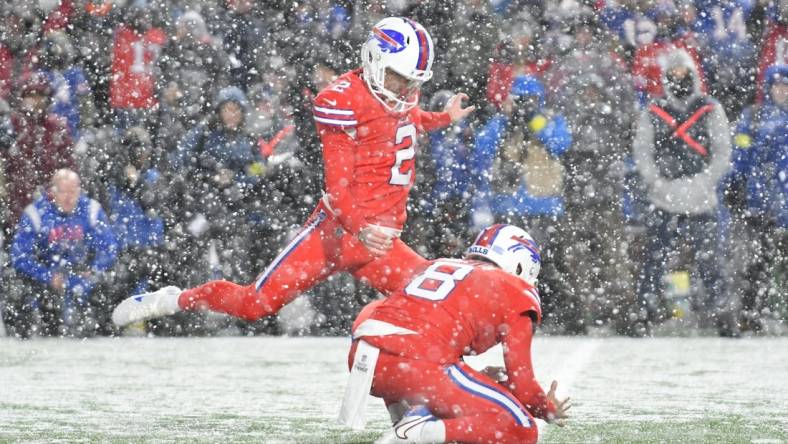 Dec 17, 2022; Orchard Park, New York, USA; Buffalo Bills place kicker Tyler Bass (2) kicks the winning field goal against the Miami Dolphins as punter Sam Martin (8) places the ball as time expires at Highmark Stadium. Mandatory Credit: Mark Konezny-USA TODAY Sports