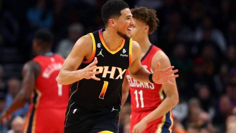 Dec 17, 2022; Phoenix, Arizona, USA; Phoenix Suns guard Devin Booker (1) reacts against the New Orleans Pelicans at Footprint Center. Mandatory Credit: Mark J. Rebilas-USA TODAY Sports