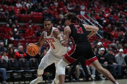 Dec 13, 2022; Lubbock, Texas, USA;  Texas Tech Red Raiders forward Kevin Obanor (0) dribbles the ball against Eastern Washington Eagles forward Casey Jones (31) in the first half at United Supermarkets Arena. Mandatory Credit: Michael C. Johnson-USA TODAY Sports
