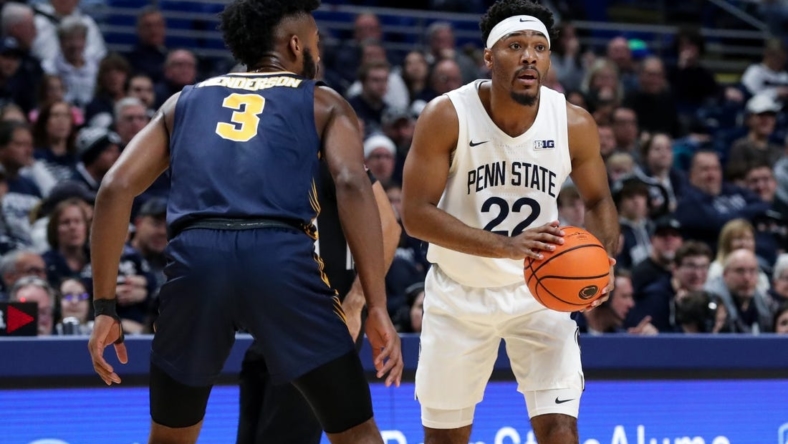 Dec 18, 2022; University Park, Pennsylvania, USA; Penn State Nittany Lions guard Jalen Pickett (22) holds the ball as Canisius Golden Griffins guard Jordan Henderson (3) defends during the first half at Bryce Jordan Center. Penn State defeated Canisius 97-67. Mandatory Credit: Matthew OHaren-USA TODAY Sports