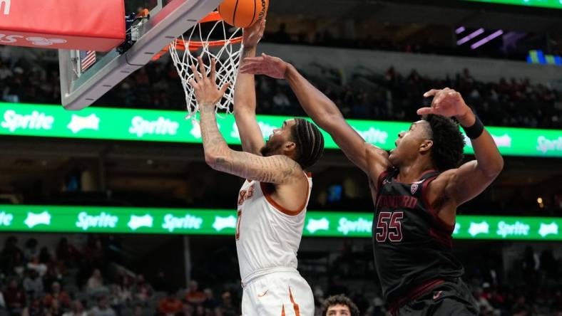 Dec 18, 2022; Dallas, Texas, USA;  Texas Longhorns forward Timmy Allen (0) makes a layup past Stanford Cardinal forward Harrison Ingram (55) during the second half at American Airlines Center. Mandatory Credit: Chris Jones-USA TODAY Sports