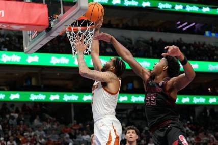 Dec 18, 2022; Dallas, Texas, USA;  Texas Longhorns forward Timmy Allen (0) makes a layup past Stanford Cardinal forward Harrison Ingram (55) during the second half at American Airlines Center. Mandatory Credit: Chris Jones-USA TODAY Sports