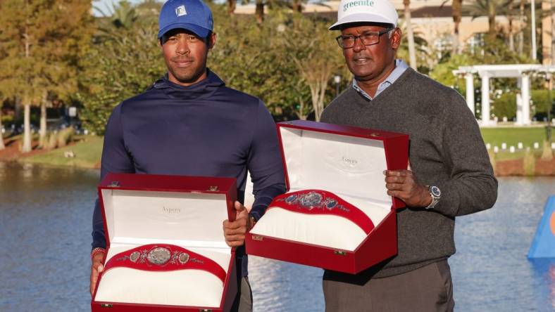 Dec 18, 2022; Orlando, Florida, USA; Vijay Singh (right) and Qass Singh hold up the Champions trophy after winning the PNC Championship golf tournament at Ritz Carlton Golf Club Grande Lakes Orlando Course. Mandatory Credit: Reinhold Matay-USA TODAY Sports