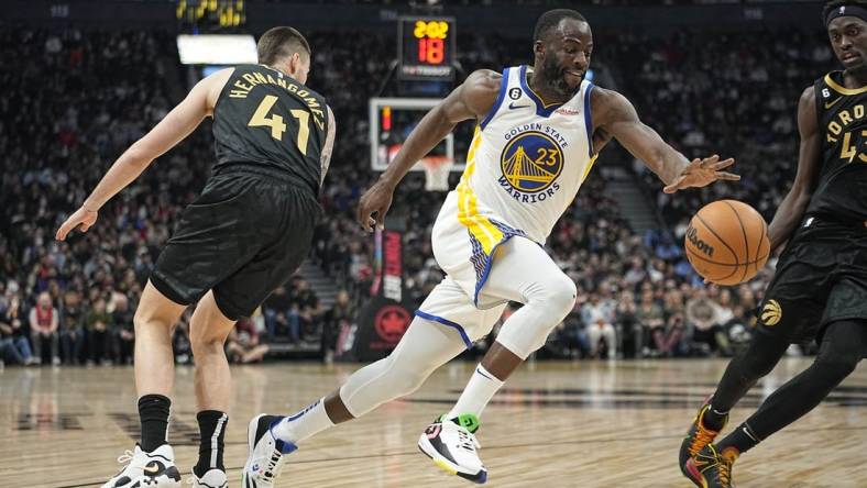 Dec 18, 2022; Toronto, Ontario, CAN; Golden State Warriors forward Draymond Green (23) drives to the net past Toronto Raptors forward Juancho Hernangomez (41) during the first half at Scotiabank Arena. Mandatory Credit: John E. Sokolowski-USA TODAY Sports