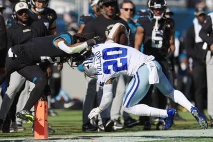 Jacksonville Jaguars safety Rayshawn Jenkins (2) tackles Dallas Cowboys running back Tony Pollard (20) during the second quarter of a regular season NFL football matchup Sunday, Dec. 18, 2022 at TIAA Bank Field in Jacksonville. [Corey Perrine/Florida Times-Union]

Jki 121822 Cowboys Jags Cp 80