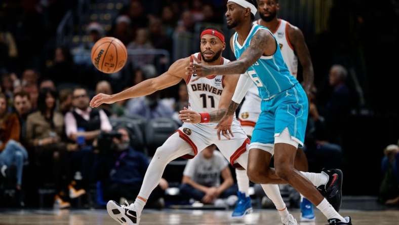 December 18, 2022;  Denver, Colorado, USA;  Charlotte Hornets forward Jalen McDaniels (6) passes the ball as Denver Nuggets forward Bruce Brown (11) guards in the fourth quarter at Ball Arena.  Mandatory Credit: Isaiah J. Downing-USA TODAY Sports
