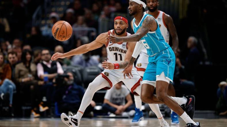 Dec 18, 2022; Denver, Colorado, USA; Charlotte Hornets forward Jalen McDaniels (6) passes the ball as Denver Nuggets forward Bruce Brown (11) guards in the fourth quarter at Ball Arena. Mandatory Credit: Isaiah J. Downing-USA TODAY Sports