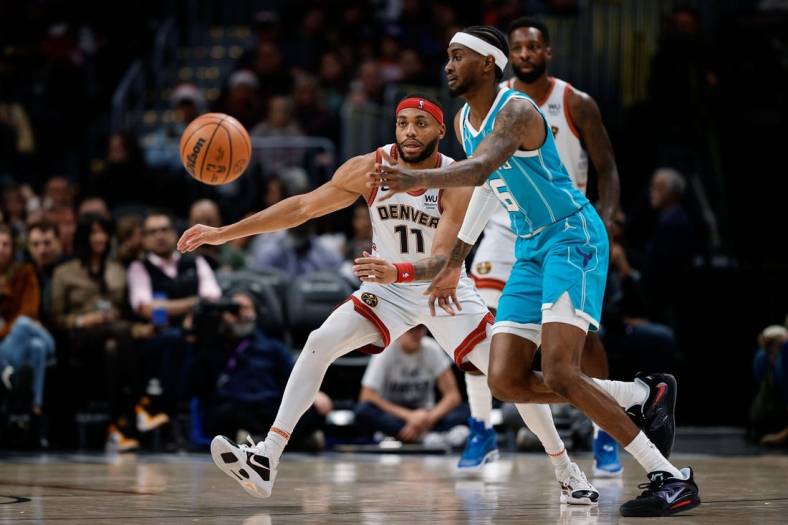 Dec 18, 2022; Denver, Colorado, USA; Charlotte Hornets forward Jalen McDaniels (6) passes the ball as Denver Nuggets forward Bruce Brown (11) guards in the fourth quarter at Ball Arena. Mandatory Credit: Isaiah J. Downing-USA TODAY Sports