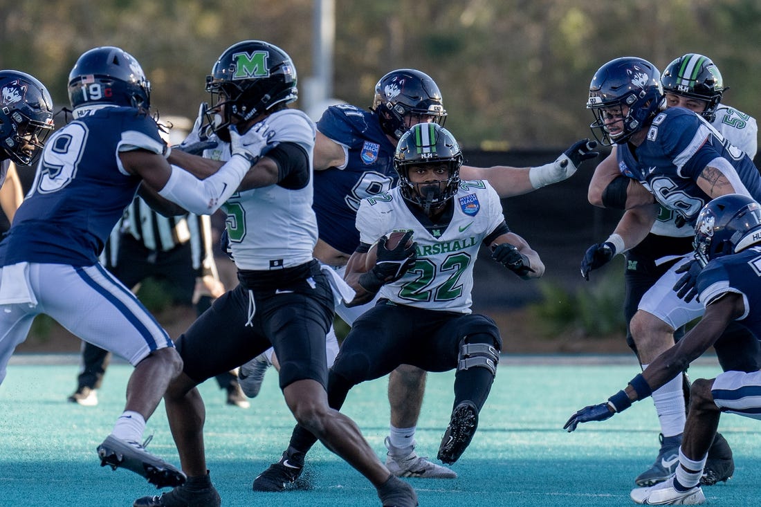 Dec 19, 2022; Conway, South Carolina, USA; Marshall Thundering Herd running back Rasheen Ali (22) looks for some running room in the first half against the Connecticut Huskies in the Myrtle Beach Bowl at Brooks Stadium. Mandatory Credit: David Yeazell-USA TODAY Sports