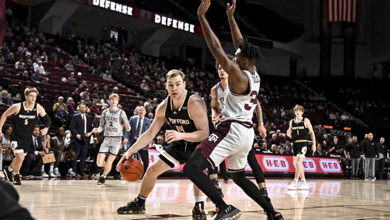 Dec 20, 2022; College Station, Texas, USA; Wofford Terriers center Kyler Filewich (14) drives as Texas A&M Aggies forward Julius Marble (34) defends during the first half at Reed Arena. Mandatory Credit: Maria Lysaker-USA TODAY Sports