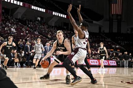 Dec 20, 2022; College Station, Texas, USA; Wofford Terriers center Kyler Filewich (14) drives as Texas A&M Aggies forward Julius Marble (34) defends during the first half at Reed Arena. Mandatory Credit: Maria Lysaker-USA TODAY Sports