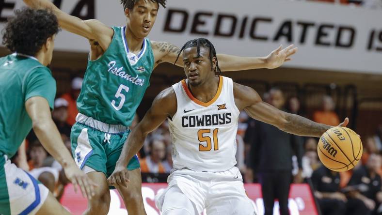 Dec 20, 2022; Stillwater, Oklahoma, USA; Oklahoma State Cowboys guard John-Michael Wright (51) is defended by Texas A&M-Corpus Christi Islanders guard Jourdyn Grandberry (5) during the first half at Gallagher-Iba Arena. Mandatory Credit: Alonzo Adams-USA TODAY Sports