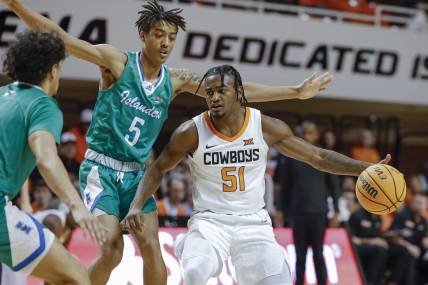 Dec 20, 2022; Stillwater, Oklahoma, USA; Oklahoma State Cowboys guard John-Michael Wright (51) is defended by Texas A&M-Corpus Christi Islanders guard Jourdyn Grandberry (5) during the first half at Gallagher-Iba Arena. Mandatory Credit: Alonzo Adams-USA TODAY Sports