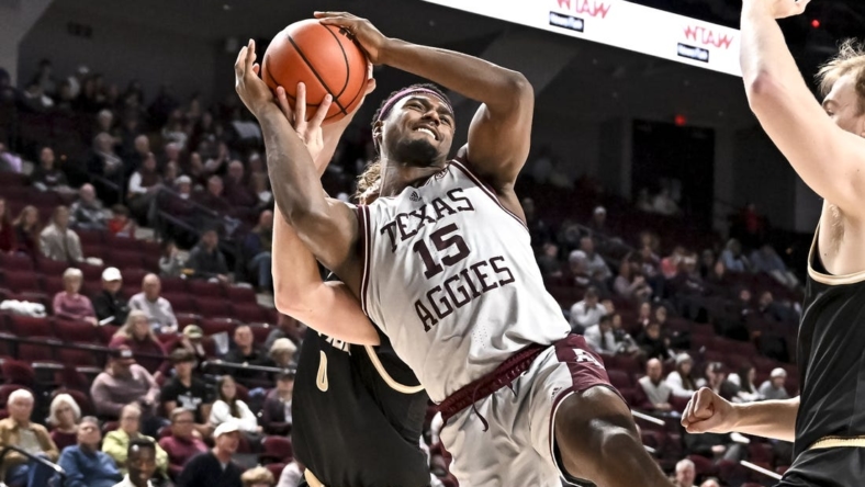 Dec 20, 2022; College Station, Texas, USA; Texas A&M Aggies forward Henry Coleman III (15) is fouled by Wofford Terriers guard Jackson Sivills (0) during the second half at Reed Arena. Mandatory Credit: Maria Lysaker-USA TODAY Sports