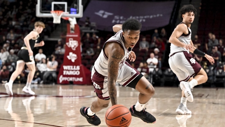 Dec 20, 2022; College Station, Texas, USA; Texas A&M Aggies guard Wade Taylor IV (4) lunges for a loose ball during the first half against the Wofford Terriers at Reed Arena. Mandatory Credit: Maria Lysaker-USA TODAY Sports