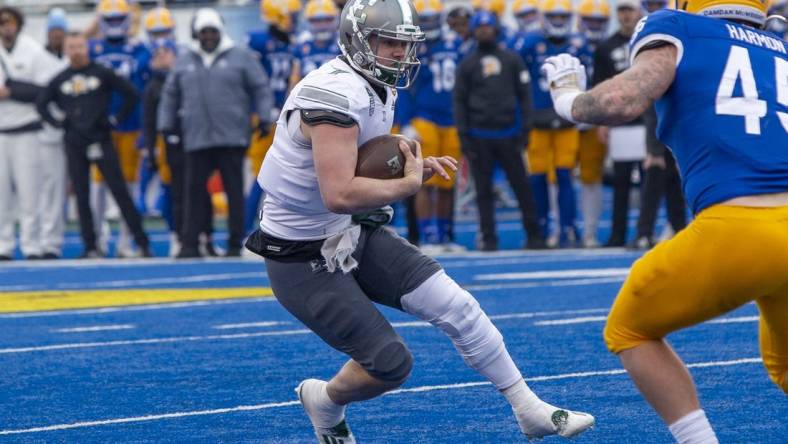 Dec 20, 2022; Boise, Idaho, USA; Eastern Michigan Eagles quarterback Taylor Powell (7) runs for a first down during the first half of action of the Famous Idaho Potato Bowl against the San Jose State Spartans at Albertsons Stadium. Mandatory Credit: Brian Losness-USA TODAY Sports