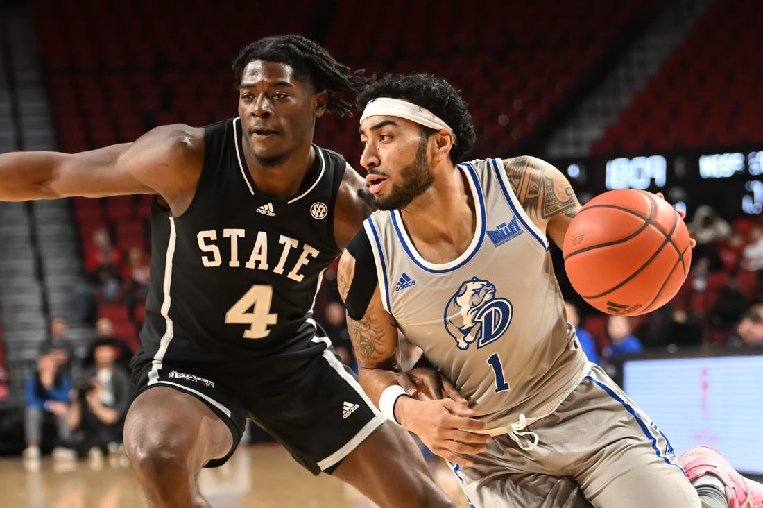 Dec 20, 2022; Lincoln, Nebraska, USA;  Drake Bulldogs guard Roman Penn (1) drives against Mississippi State Bulldogs guard Cameron Matthews (4) in the first half at Pinnacle Bank Arena. Mandatory Credit: Steven Branscombe-USA TODAY Sports