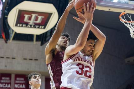 Dec 20, 2022; Bloomington, Indiana, USA; Indiana Hoosiers guard Trey Galloway (32) rebounds the ball while Elon Phoenix guard Max Mackinnon (3) defends in the first half at Simon Skjodt Assembly Hall. Mandatory Credit: Trevor Ruszkowski-USA TODAY Sports