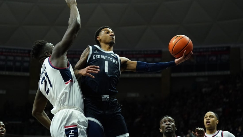 Dec 20, 2022; Storrs, Connecticut, USA; Georgetown Hoyas guard Primo Spears (1) shoots against UConn Huskies forward Adama Sanogo (21) in the second half at Harry A. Gampel Pavilion. Mandatory Credit: David Butler II-USA TODAY Sports