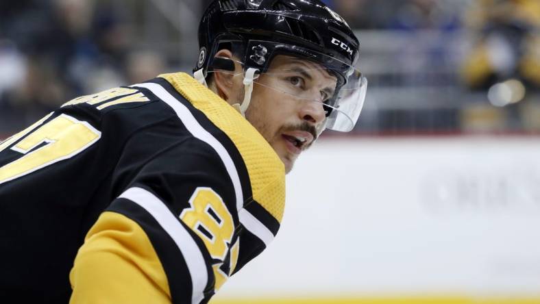 Dec 20, 2022; Pittsburgh, Pennsylvania, USA;  Pittsburgh Penguins center Sidney Crosby (87) looks on at the face-off circle against the New York Rangers during the third period at PPG Paints Arena. The Penguins won 3-2. Mandatory Credit: Charles LeClaire-USA TODAY Sports