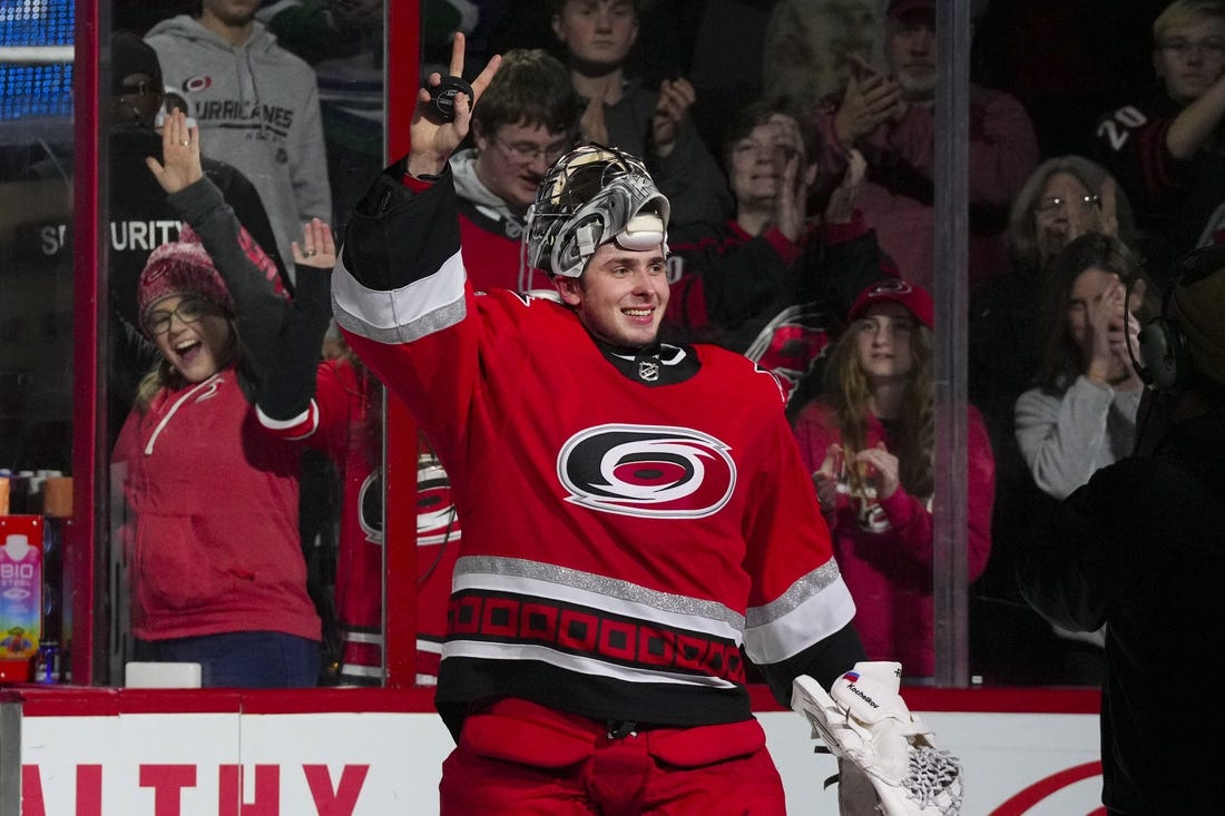 Dec 20, 2022; Raleigh, North Carolina, USA;  Carolina Hurricanes goaltender Pyotr Kochetkov (52) celebrates their victory after the game against the New Jersey Devils at PNC Arena. Mandatory Credit: James Guillory-USA TODAY Sports
