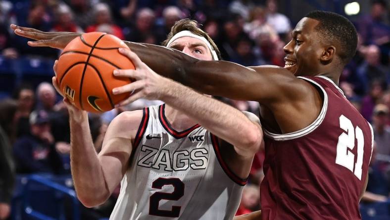 Dec 20, 2022; Spokane, Washington, USA; Gonzaga Bulldogs forward Drew Timme (2) is fouled by Montana Grizzlies forward Laolu Oke (21) in the second half at McCarthey Athletic Center. Gonzaga won 85-75. Mandatory Credit: James Snook-USA TODAY Sports