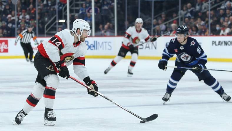 Dec 20, 2022; Winnipeg, Manitoba, CAN; Ottawa Senators forward Tyler Motte (14) skates away from Winnipeg Jets forward Cole Perfetti (91) during the first period at Canada Life Centre. Mandatory Credit: Terrence Lee-USA TODAY Sports