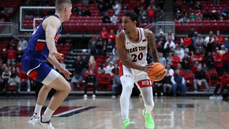 Dec 21, 2022; Lubbock, Texas, USA;  Texas Tech Red Raiders guard Jaylon Tyson (20) works the ball against Houston Christian Huskies guard Maks Klanjscek (13) in the first half at United Supermarkets Arena. Mandatory Credit: Michael C. Johnson-USA TODAY Sports