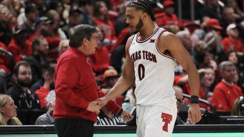 Dec 21, 2022; Lubbock, Texas, USA;  Texas Tech Red Raiders head coach Mark Adams greets forward Kevin Obanor (0) as he leaves the game in the second half against the Houston Christian Huskies at United Supermarkets Arena. Mandatory Credit: Michael C. Johnson-USA TODAY Sports