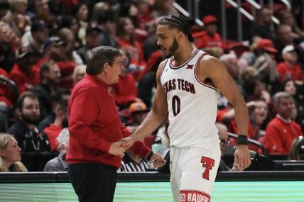 Dec 21, 2022; Lubbock, Texas, USA;  Texas Tech Red Raiders head coach Mark Adams greets forward Kevin Obanor (0) as he leaves the game in the second half against the Houston Christian Huskies at United Supermarkets Arena. Mandatory Credit: Michael C. Johnson-USA TODAY Sports