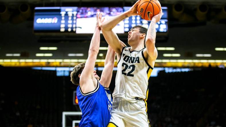 Iowa forward Patrick McCaffery (22) shoots a basket as Eastern Illinois guard Dan Luers defends during a NCAA men's basketball game, Wednesday, Dec. 21, 2022, at Carver-Hawkeye Arena in Iowa City, Iowa.

221221 Eastern Illinois Iowa Mbb 022 Jpg