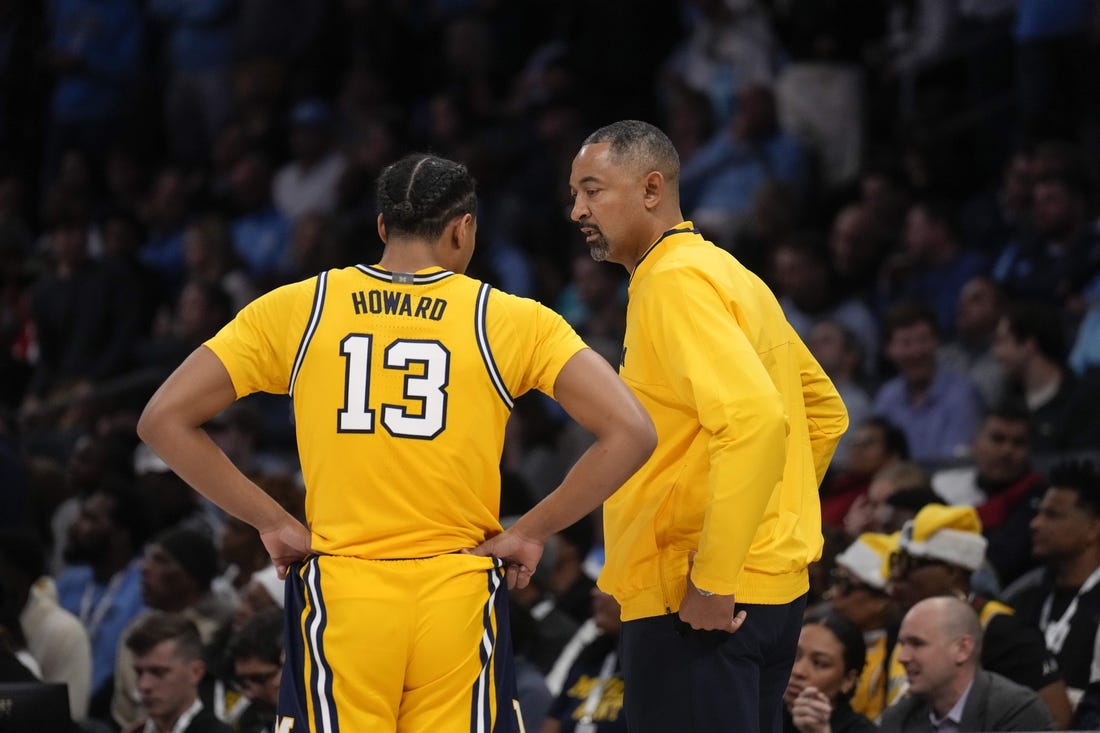 Dec 21, 2022; Charlotte, North Carolina, USA; Michigan Wolverines head coach Juwan Howard talks with guard Jett Howard (13) during the first half against the North Carolina Tar Heels at the Jumpman Classic at the Spectrum Center. Mandatory Credit: Jim Dedmon-USA TODAY Sports