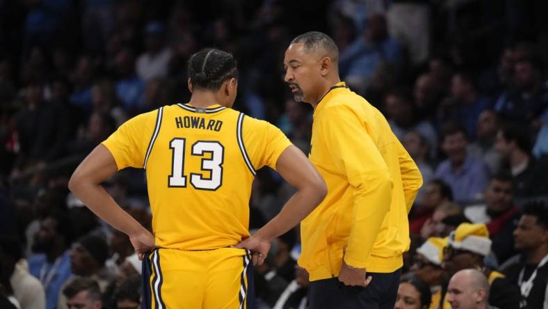 Dec 21, 2022; Charlotte, North Carolina, USA; Michigan Wolverines head coach Juwan Howard talks with guard Jett Howard (13) during the first half against the North Carolina Tar Heels at the Jumpman Classic at the Spectrum Center. Mandatory Credit: Jim Dedmon-USA TODAY Sports