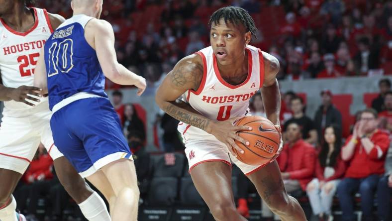 Dec 21, 2022; Houston, Texas, USA; Houston Cougars guard Marcus Sasser (0) grabs a rebound during the first half against the McNeese State Cowboys at Fertitta Center. Mandatory Credit: Troy Taormina-USA TODAY Sports