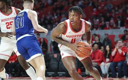 Dec 21, 2022; Houston, Texas, USA; Houston Cougars guard Marcus Sasser (0) grabs a rebound during the first half against the McNeese State Cowboys at Fertitta Center. Mandatory Credit: Troy Taormina-USA TODAY Sports