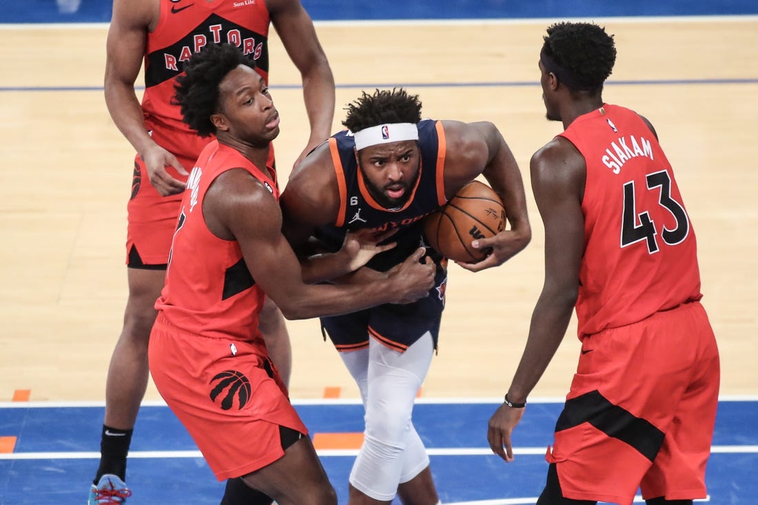 Dec 21, 2022; New York, New York, USA;  New York Knicks center Mitchell Robinson (23) and Toronto Raptors forward O.G. Anunoby (3) play for the ball in the second quarter at Madison Square Garden. Mandatory Credit: Wendell Cruz-USA TODAY Sports