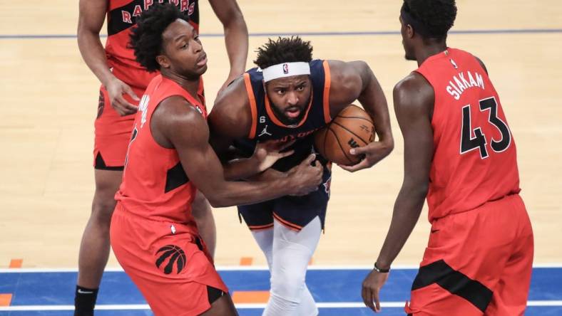 Dec 21, 2022; New York, New York, USA;  New York Knicks center Mitchell Robinson (23) and Toronto Raptors forward O.G. Anunoby (3) play for the ball in the second quarter at Madison Square Garden. Mandatory Credit: Wendell Cruz-USA TODAY Sports