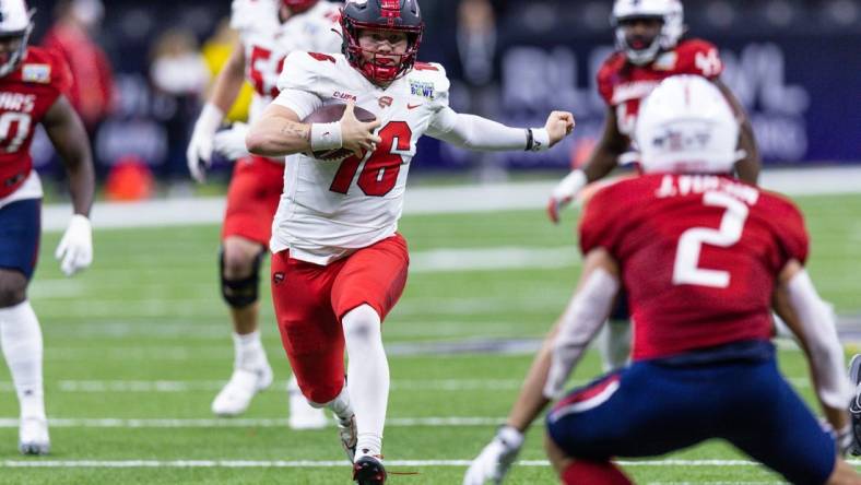 Dec 21, 2022; New Orleans, Louisiana, USA;  Western Kentucky Hilltoppers quarterback Austin Reed (16) scrambles out the pocket against the South Alabama Jaguars during the first half at Caesars Superdome. Mandatory Credit: Stephen Lew-USA TODAY Sports