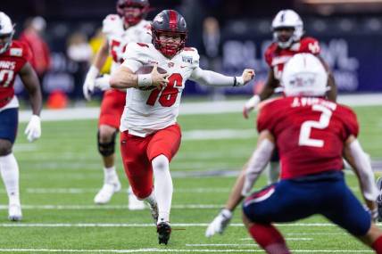 Dec 21, 2022; New Orleans, Louisiana, USA;  Western Kentucky Hilltoppers quarterback Austin Reed (16) scrambles out the pocket against the South Alabama Jaguars during the first half at Caesars Superdome. Mandatory Credit: Stephen Lew-USA TODAY Sports