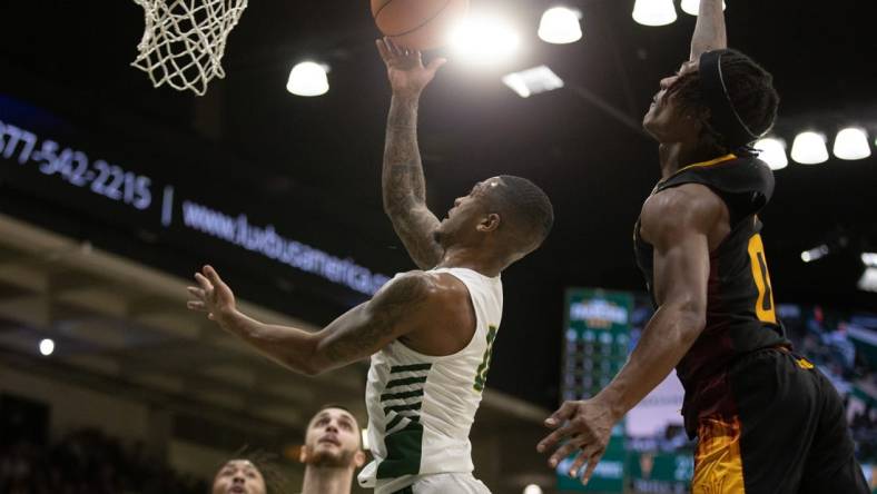 Dec 21, 2022; San Francisco, California, USA; San Francisco Dons guard Khalil Shabazz (left) is fouled by Arizona State Sun Devils guard DJ Horne (0) as he drives to the basket during the first half at War Memorial at the Sobrato Center. Mandatory Credit: D. Ross Cameron-USA TODAY Sports